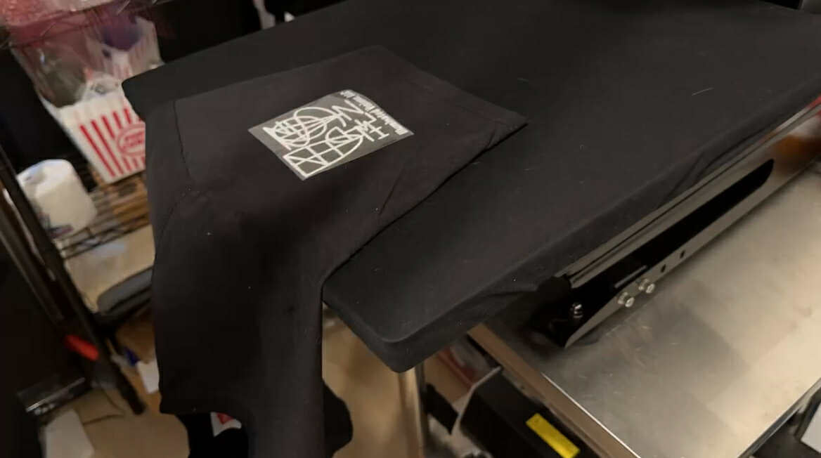 Load video: Pressing a side sleeve T-shirt